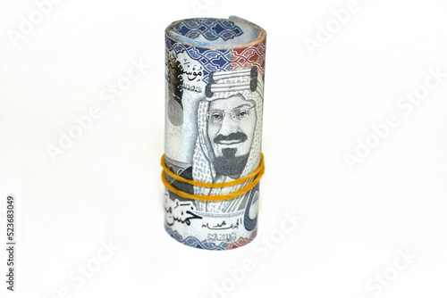 500 Five hundred Saudi Arabia money roll riyals banknotes isolated on white background, Saudi riyals cash money bills rolled up with rubber bands features an image of king AbdulAziz Al Saud photo