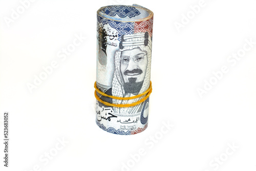 500 Five hundred Saudi Arabia money roll riyals banknotes isolated on white background, Saudi riyals cash money bills rolled up with rubber bands features an image of king AbdulAziz Al Saud photo