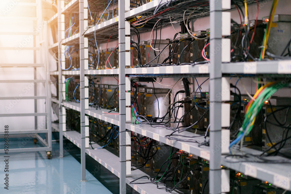 Bitcoin miners in farm. ASIC mining equipment for cryptocurrency on racks steel container. Blockchain technology concepts Bitcoin miners in farm. ASIC mining equipment for cryptocurrency on racks steel container. Blockchain technology concepts
