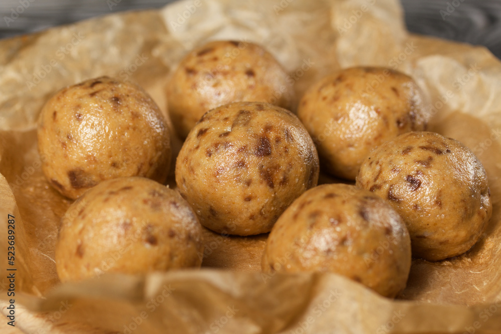 Useful homemade sweets. Coconut flour with dark chocolate. In the form of balls. On craft paper. Useful homemade sweets. Coconut flour with dark chocolate. In the form of balls. On craft paper.