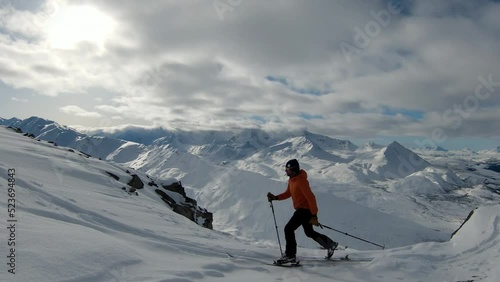Wallpaper Mural Panning Shot Of Male Tourist With Ski Poles Walking On Snowy Mountain During Vacation - Valdez-Cordova, Alaska Torontodigital.ca