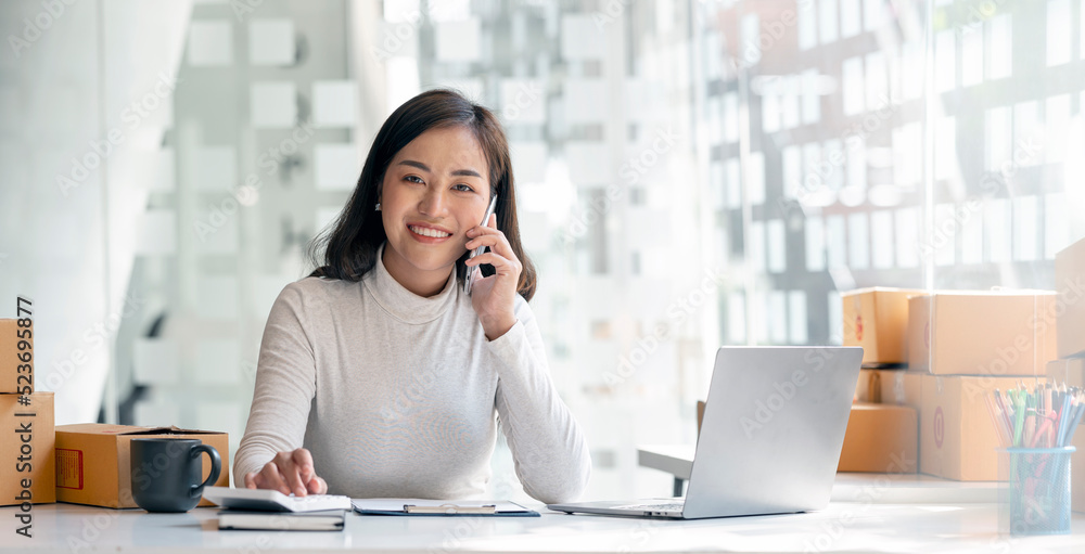 Portrait asian female owner startup business using mobile phone, prepare parcel delivery in sme supply chain, start up small business concept. Portrait asian female owner startup business using mobile phone, prepare parcel delivery in sme supply chain, start up small business concept.