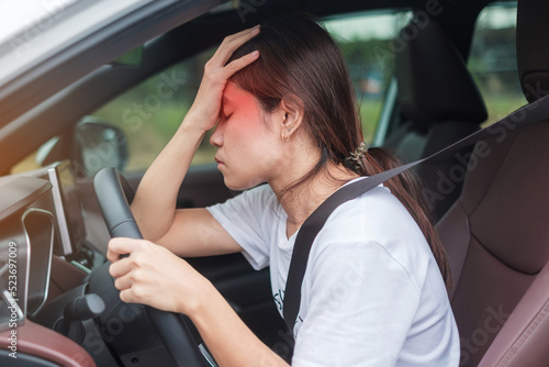 woman feeling stress and angry during drive car long time. Asian girl tired and fatigue having headache stop after driving car in traffic jam. Sleepy, stretching and drunk concept © Jo Panuwat D