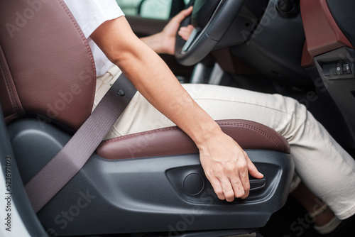 Hand adjust car seat before drive on the road . Ergonomic and safety transportation concept