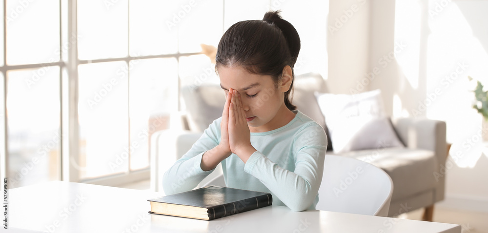 Cute little Asian girl praying at home Cute little Asian girl praying at home