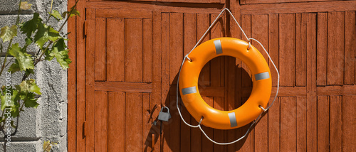 Bright lifebuoy ring hanging on gates photo