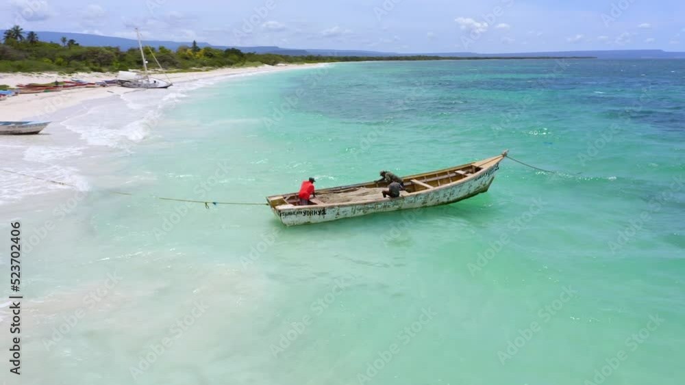 Local fishermen in boat in shallows of tropical Caribbean, Playa Pedernales Local fishermen in boat in shallows of tropical Caribbean, Playa Pedernales