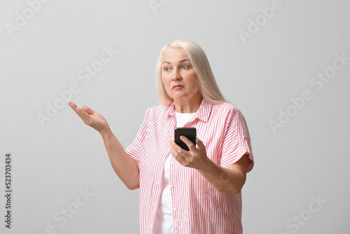 Upset mature woman with mob...