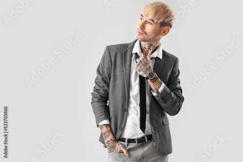 Young tattooed man with nec...