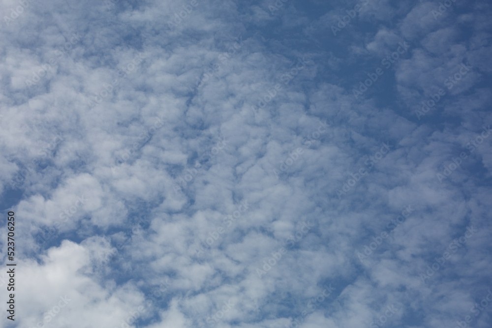 The blue sky is covered with beautiful white clouds in the summer. The blue sky is covered with beautiful white clouds in the summer.