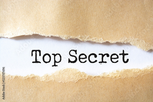 Torn paper revealing the words "Top Secret"