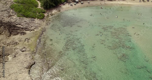 Aerial view of people swimming in transparent waters of the Jobos beach, in Puerto rico, USA - circling, drone shot photo