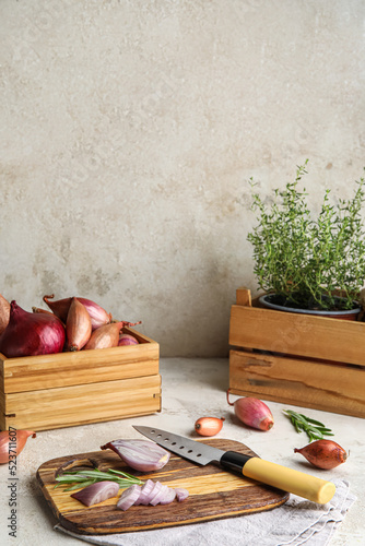 Wooden board with cut onion...