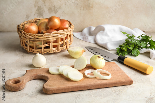 Wooden board with cut onion...
