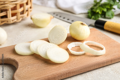 Wooden board with cut onion...