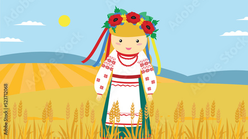 A girl in a Ukrainian vyshyvanka and a wreath stands in a field
