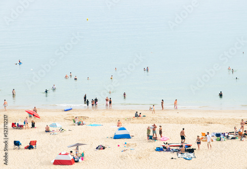 Small crowd on Beach and swimming in the Sea late summer afternoon, Bournemouth UK (ID: 523712217)