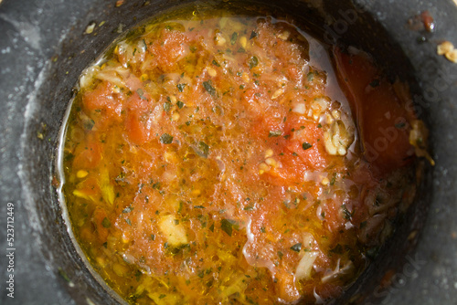 close-up of homemade tomato, garlic, oil and basil based preparation
in a mortar for the Italian recipe known as "pasta alla trapanese"
