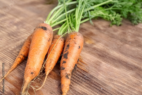 Fresh juicy carrots on wood...