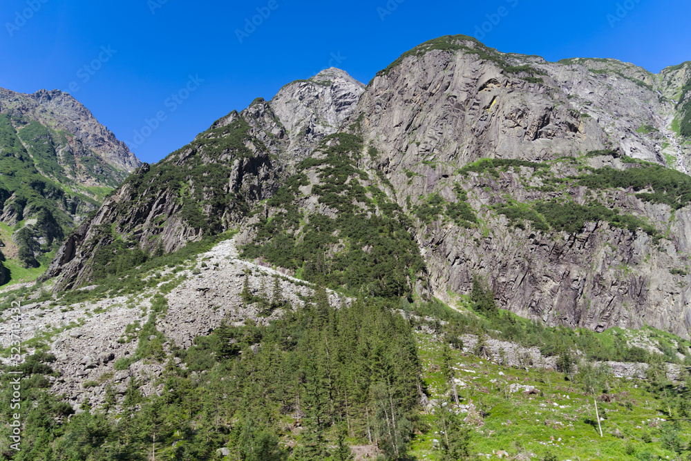 Mountain panorama at Swiss mountain pass Grimsel, Canton Bern, on a sunny summer day. Photo taken July 3rd, 2022, Grimsel Pass, Switzerland.