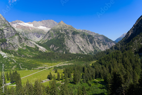 Mountain panorama at Swiss mountain pass Grimsel, Canton Bern, on a sunny summer day. Photo taken July 3rd, 2022, Grimsel Pass, Switzerland. © Michael Derrer Fuchs