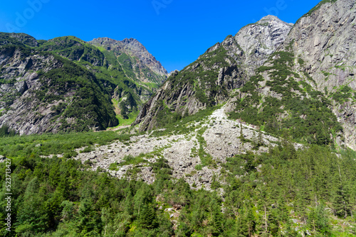 Fototapeta Naklejka Na Ścianę i Meble -  Mountain panorama at Swiss mountain pass Grimsel, Canton Bern, on a sunny summer day. Photo taken July 3rd, 2022, Grimsel Pass, Switzerland.