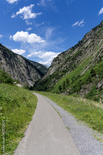 Scenic view of pedestrian pathway with rocks and mountains at Schöllenen Gorge, Canton Uri, on a sunny summer day. Photo taken July 3rd, 2022, Schöllenen Gorge, Switzerland.