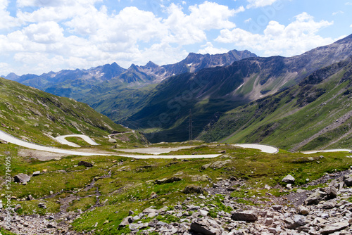Scenic view of Bedretto Valley, Canton Ticino, with mountain pass road of Nufenen Pass on a sunny summer day. Photo taken July 3rd, 2022, Val Bedretto, Switzerland.