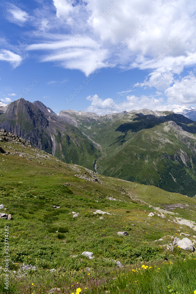 Beautiful mountain panorama seen from summt of Nufenen Pass on a sunny summer day. Photo taken July 3rd, 2022, Nufenen Pass, Switzerland.