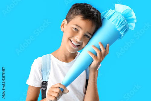 Little boy with school cone...