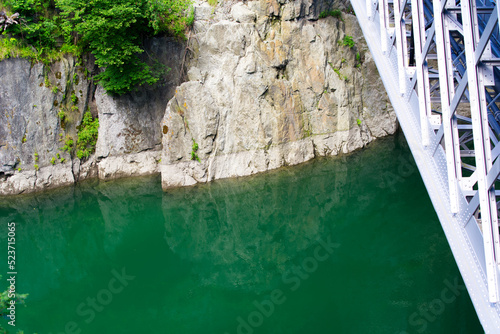 Scenic view from bridge over Reuss River with rock and reflections of the sky at mountain village Göschenen on a sunny summer day. Photo taken July 3rd, 2022, Switzerland.