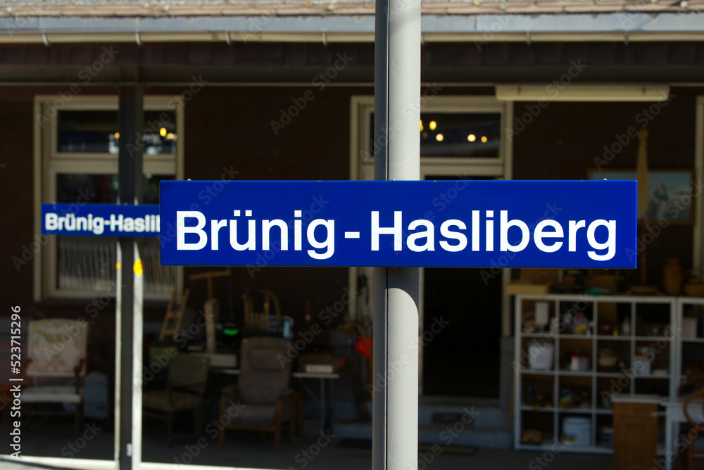 Blue sign at railway station Brünig-Hasliberg, Canton Obwalden and Canton Bern, on a sunny summer day. Photo taken July 3rd, 2022, Brünig-Hasliberg, Switzerland.