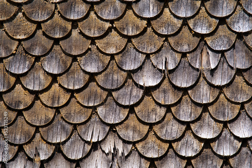 Close-up of wooden shingles facade of historic house at mountain village Göschenen, Canton Uri, on a sunny summer day. Photo taken July 3rd, 2022, Göschenen, Switzerland. photo