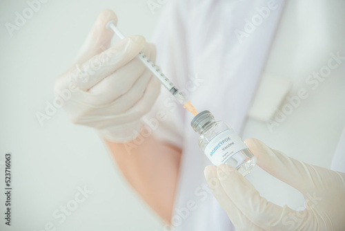 A doctor or scientist is holding a vaccine vial for monkeypox or clade.
