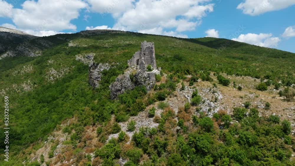 Aerial View Of Old Glavas Fortress With Man Standing On The Ledge In Croatia - drone pullback Aerial View Of Old Glavas Fortress With Man Standing On The Ledge In Croatia - drone pullback