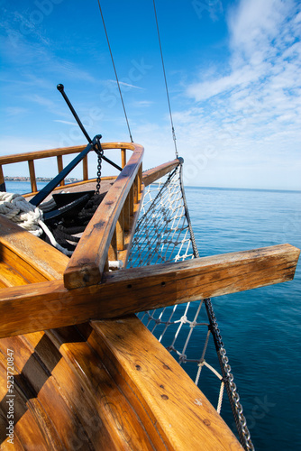 Valokuvatapetti wooden prow on a small boat with decorative fishing nets in front and raised anc