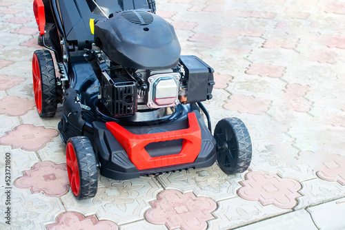 Close-up of lawn mower. Modern petrol lawn mower. © Andrei