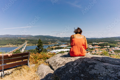 Woman contemplating the landscape from a mountain