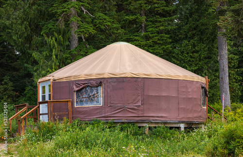 Urta nomadic house in the mountains. Yurt traditional nomadic house on the green grass in a forest.