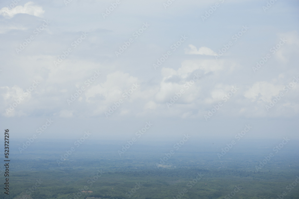 Aerial landscape view with a drone of meadow and cloudy sky horizon. Beautiful natural view of green fields and sky. Foggy weather drone shot of a hilly jungle area and sky horizon. Aerial landscape view with a drone of meadow and cloudy sky horizon. Beautiful natural view of green fields and sky. Foggy weather drone shot of a hilly jungle area and sky horizon.
