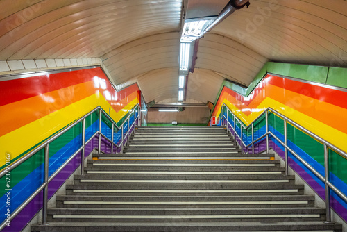 Stairs of the metro station in the Chueca neighborhood of Madrid in awe with the colors of the lgtb rainbow flag photo