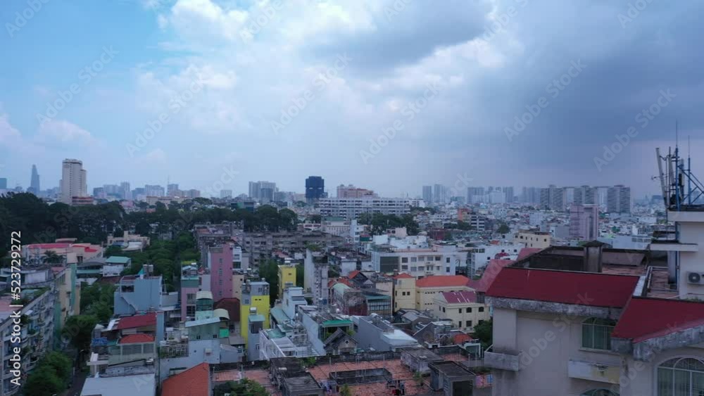 Old communist ,brutalist apartment building in Cho lon or Chinatown district of Ho Chi Minh City, Vietnam. High angle looking down. Long pan from skyline right to rooftops. Old communist ,brutalist apartment building in Cho lon or Chinatown district of Ho Chi Minh City, Vietnam. High angle looking down. Long pan from skyline right to rooftops.