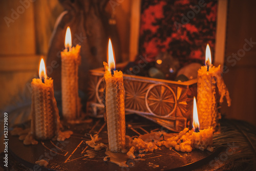 Candle burns on the altar, magic among candles, clean negative energy, wicca concept photo