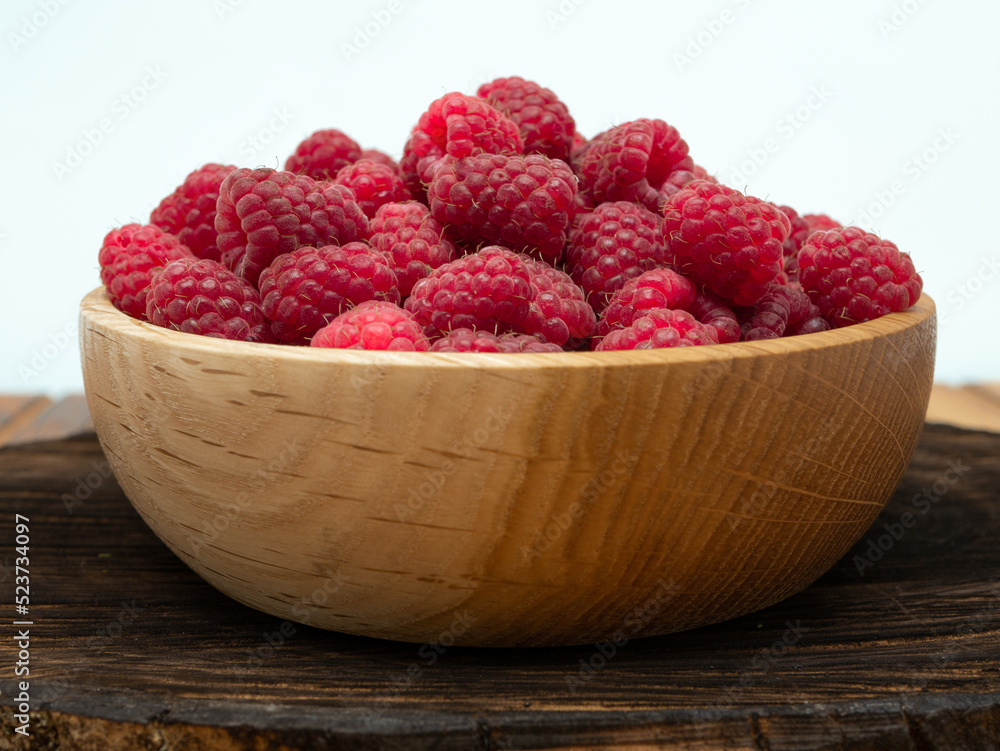 Raspberries in wooden bowl. Raspberry with copy space for text Raspberries in wooden bowl. Raspberry with copy space for text