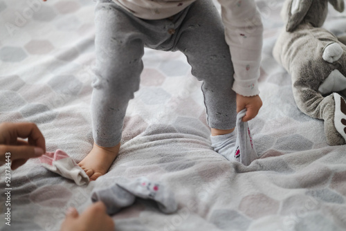 toddler takes off his sock