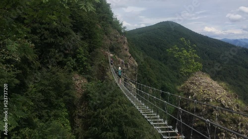 Suspension bridge at Skalka, Slovakia, with brave unrecognizable tourists photo