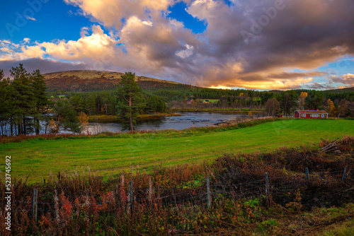 Bilde på lerret Sunset over a wooden cabin and Glomma River in Innlandet county, Norway