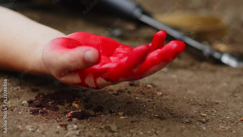 A wounded soldier bleeds out on the battlefield. Blood flows from the arm of a soldier A wounded soldier bleeds out on the battlefield. Blood flows from the arm of a soldier