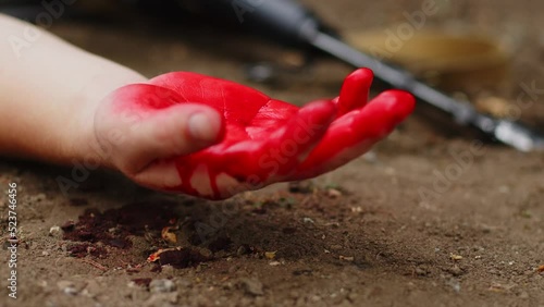 A wounded soldier bleeds out on the battlefield. Blood flows from the arm of a soldier