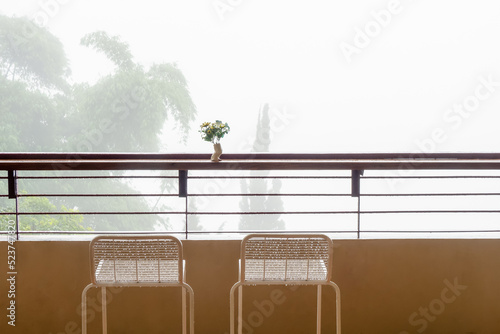Sunny terrace with chairs and a lot of fog